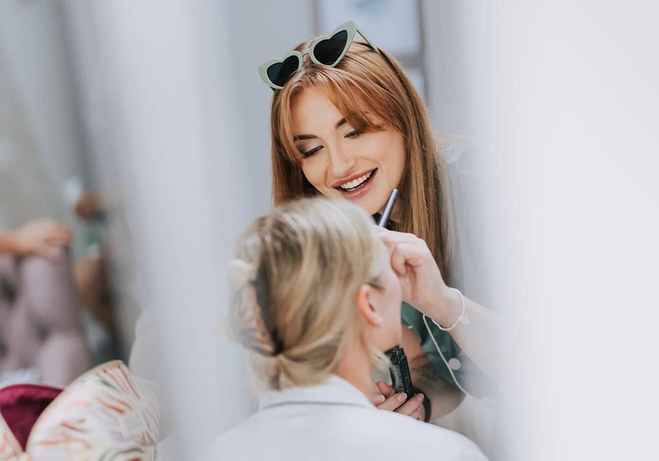 Imogen Nia applying bridal makeup during a wedding morning